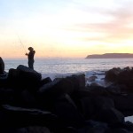 Fisherman Getting Splashed at Sunset