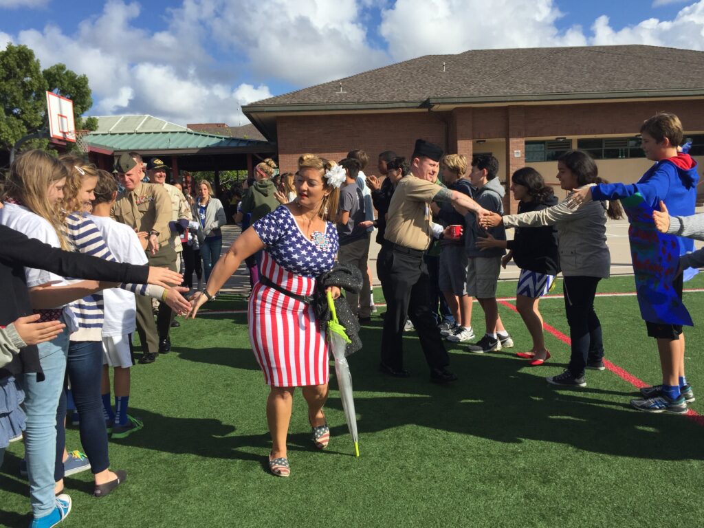 CMS students formed a human tunnel and cheered for the Veterans, who high-fived them as they walked past students.