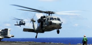 MH-60S Sea Hawk helicopter from the "Eightballers" of Helicopter Sea Combat Squadron (HSC) 8, front, and an MH-60R Sea Hawk helicopter from the "Raptors" of Helicopter Maritime Strike Squadron (HSM) 71