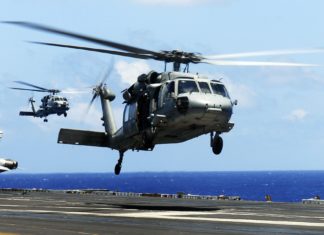 MH-60S Sea Hawk helicopter from the "Eightballers" of Helicopter Sea Combat Squadron (HSC) 8, front, and an MH-60R Sea Hawk helicopter from the "Raptors" of Helicopter Maritime Strike Squadron (HSM) 71