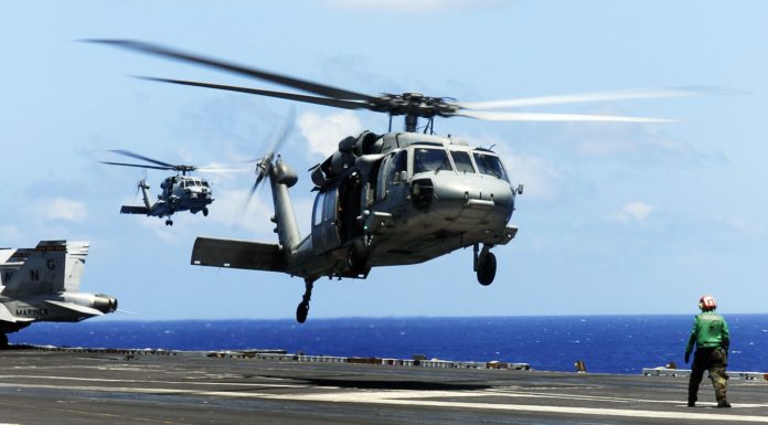 MH-60S Sea Hawk helicopter from the "Eightballers" of Helicopter Sea Combat Squadron (HSC) 8, front, and an MH-60R Sea Hawk helicopter from the "Raptors" of Helicopter Maritime Strike Squadron (HSM) 71