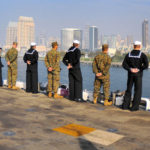 Sailors and Marines line ship