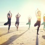 hotel-del-coronado-recreation-beach-yoga-class-doing-tree-pose