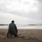 man on beach storm-4688918_1920