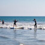 happy kids surfing ocean