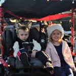 Alexander & Amelia Murray strike a pose on back of their golf cart