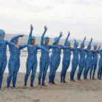 Sharkbait Mamas pose on beach