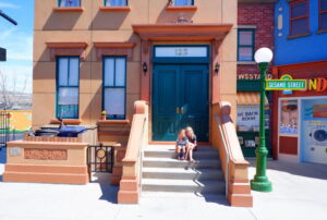 Cole and Jules Lawson on the Sesame Street 123 address stoop
