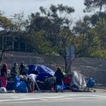 unhoused homeless cleaning up