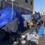 unhoused homeless picking up trash