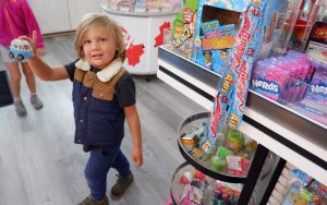 At Seaside Candy, Cole Lawson, age 4, enjoys the miniature car toys.