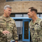 U.S. Army Gen. Bryan P. Fenton, commander, U.S. Special Operations Command, speaks with Rear Adm. Keith Davids, commander, Naval Special Warfare Command 230602-N-EZ002-1004