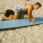 Joann Trumbull waxing her favorite long board in November 1958.