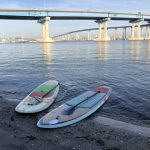 paddle boards under bridge