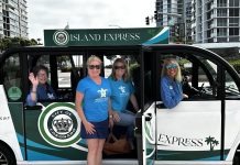 Emerald Keepers dressed in blue shirts are taking the Island Express.