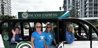 Emerald Keepers dressed in blue shirts are taking the Island Express.