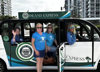 Emerald Keepers dressed in blue shirts are taking the Island Express.