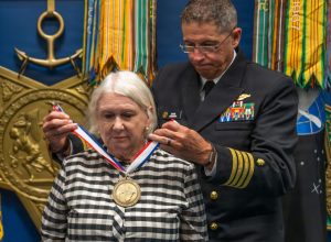 Karol McClelland, President of Coronado Rotary Club, receives a medallion during the 2026 Spirit of Hope (SoH) Award ceremony in the Pentagon Hall of Heroes in Arlington, Virginia, Sept. 23, 2026. Robert Salesses, Department of War Director of Administration and Management, hosted the event. (U.S. Army photo by Christopher Kaufmann)