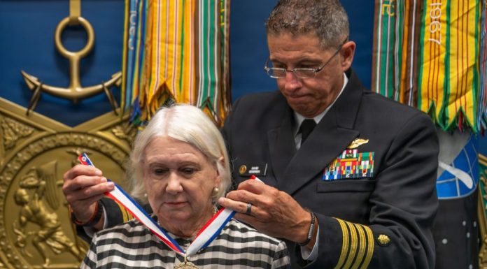 Karol McClelland, President of Coronado Rotary Club, receives a medallion during the 2026 Spirit of Hope (SoH) Award ceremony in the Pentagon Hall of Heroes in Arlington, Virginia, Sept. 23, 2026. Robert Salesses, Department of War Director of Administration and Management, hosted the event. (U.S. Army photo by Christopher Kaufmann)