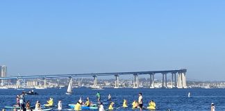 SD Climate week paddle out in Glorietta Bay with bridge in background.