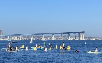 SD Climate week paddle out in Glorietta Bay with bridge in background.