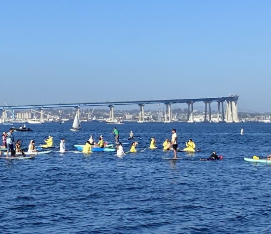 SD Climate week paddle out in Glorietta Bay with bridge in background.