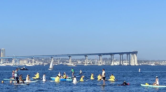 SD Climate week paddle out in Glorietta Bay with bridge in background.