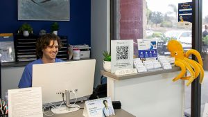A Healthtopia clinical care worker at the reception area of integrative primary care in San Diego